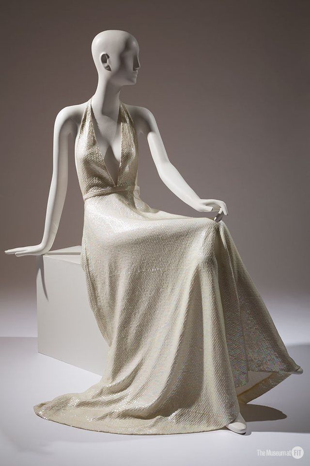 Halston evening dress: Sequined polyester 1974, USA Gift of Celanese, 80.128.12 YSL + Halston: Fashioning the 70s Photograph by Eileen Costa © The Museum at FIT.