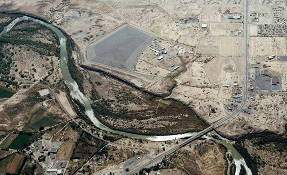 Shiprock, New Mexico uranium mill aerial photo: Aerial photograph of Shiprock, New Mexico uranium mill tailings pile and surrounding area, 2002. The view is looking toward the sout