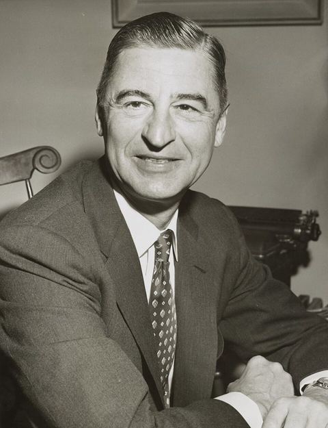 Dr. Seuss: Children's author Ted Geisel, (Dr. Seuss), three-quarter length portrait, seated at desk, facing front] / World Telegram