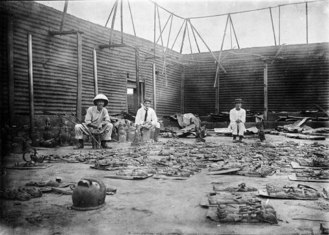 Interior of Oba's compound burnt during siege of Benin City, 1897: Interior of Oba's compound burnt during seige of Benin City (present day Nigeria) , with bronze plaques in the fo