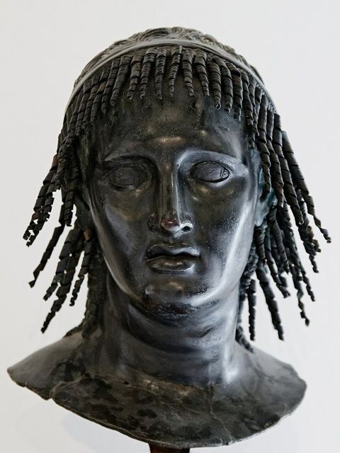 Ptolemy Apion MAN Napoli Inv5598: Herm head with corkscrew curls that may be a 18th-century restoration, traditionally identified as Ptolemy Apion, king of Cyrene, or Berenice.
