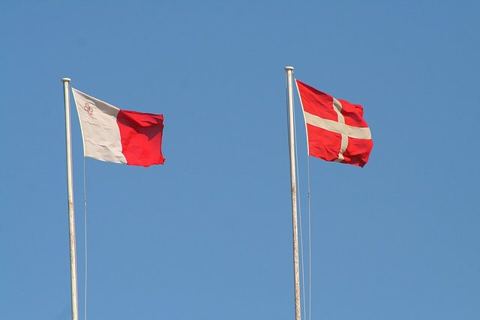 The Flag of Malta and the Flag of the Sovereign Military Order of Malta - Fort St. Angelo: The flag on the left is the Maltese National Flag, the flag on the right is the Flag of t