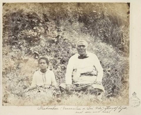 Cakobau with son and heir, 1861: Seated portrait of Thakombau, king of the Fijian group and his son (possibly Ratu Epeli Nailatikau). When the British HMS Pelorus was in Fiji in 18